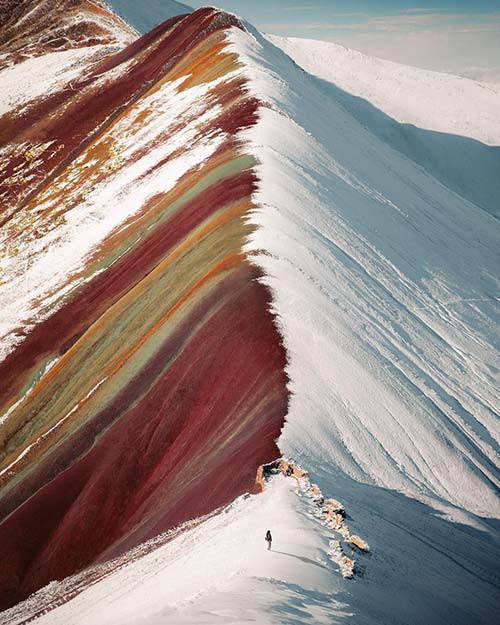 Vinicunca Rainbow Mountain of Cusco Peru half covered of snow