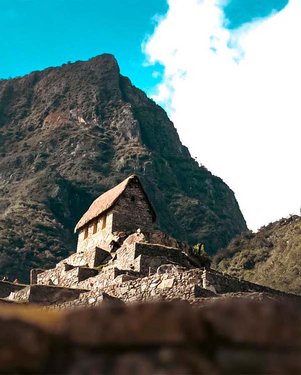 Woman hiking the incredible ancient Inca Trail to Machu Picchu near the cliff